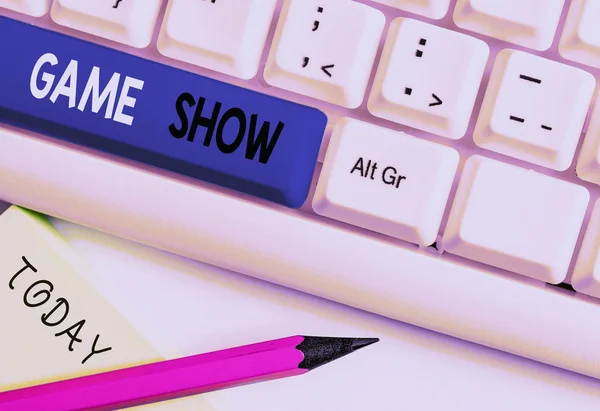 Writing note showing Game Show. Business photo showcasing Program in television or radio with players that win prizes White pc keyboard with note paper above the white background.