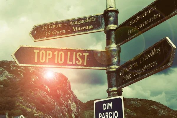 Word writing text Top 10 List. Business concept for the ten most important or successful items in a particular list Road sign on the crossroads with blue cloudy sky in the background.