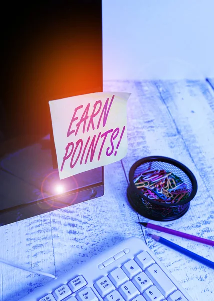 Text sign showing Earn Points. Conceptual photo collecting scores in order qualify to win big prize Note paper taped to black computer screen near keyboard and stationary.