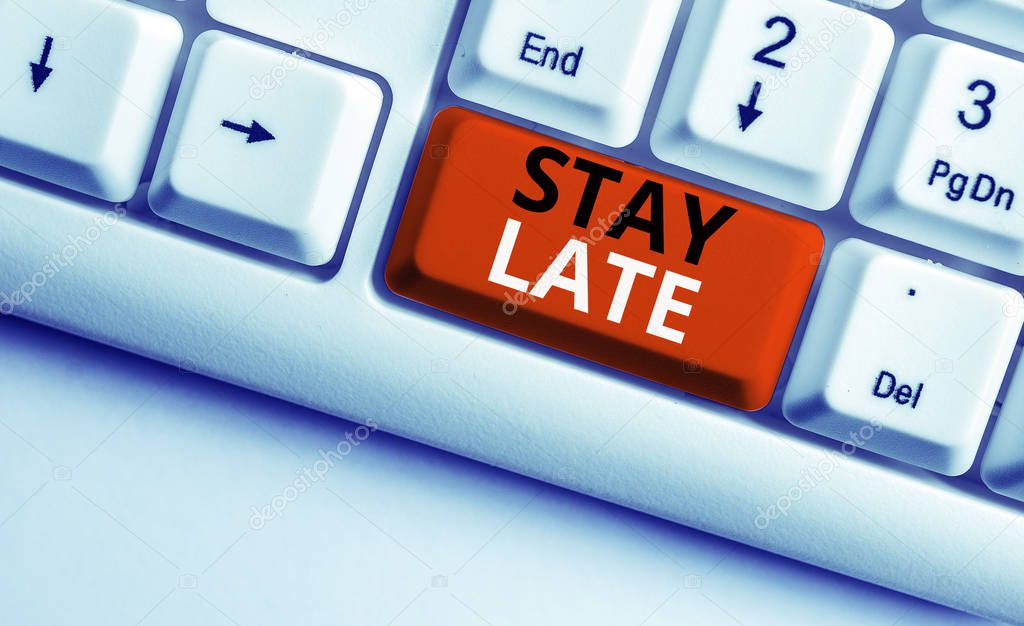 Writing note showing Stay Late. Business photo showcasing A routine in which a demonstrating goes to somewhere out of time White pc keyboard with note paper above the white background.
