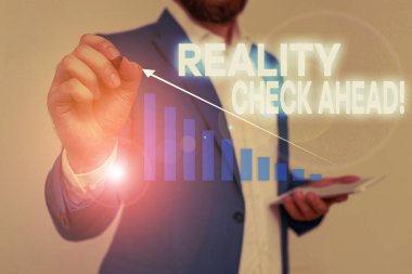 Reality Check Ahead'i gösteren bir not yazıyorum. İş fotoğraf vitrin onları durumlar veya zorluklar hakkında gerçeği tanımak yapar Erkek sunum akıllı cihaz sunan resmi iş elbisesi giymek.