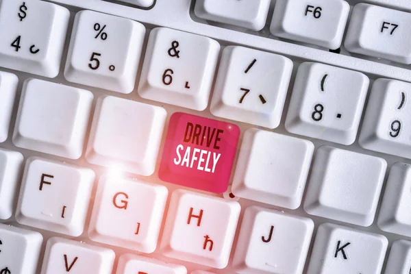 Handwriting text writing Drive Safely. Concept meaning you should follow the rules of the road and abide laws White pc keyboard with empty note paper above white background key copy space.