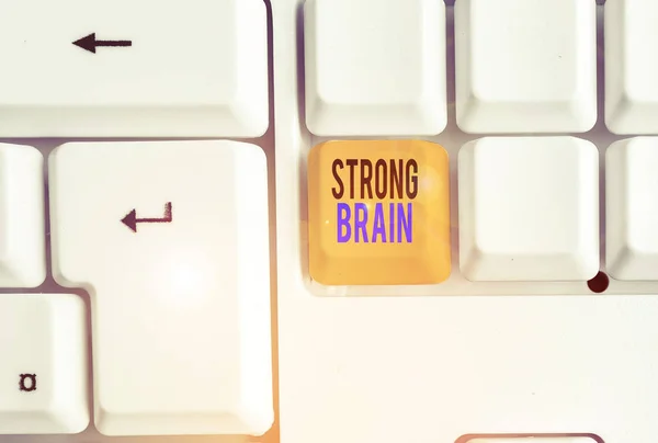 Handwriting text Strong Brain. Concept meaning own firm attitudes and opinions and are not easily influenced White pc keyboard with empty note paper above white background key copy space.