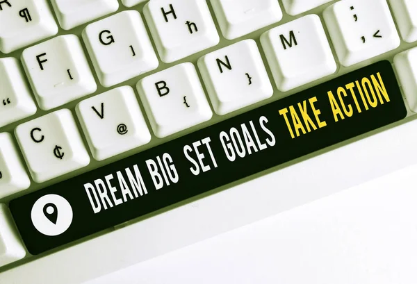 Text sign showing Dream Big Set Goals Take Action. Conceptual photo Motivation to follow your dreams Inspiration White pc keyboard with empty note paper above white background key copy space.