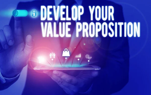 Text sign showing Develop Your Value Proposition. Conceptual photo Prepare marketing strategy sales pitch Male human wear formal work suit presenting presentation using smart device. — Stock Photo, Image