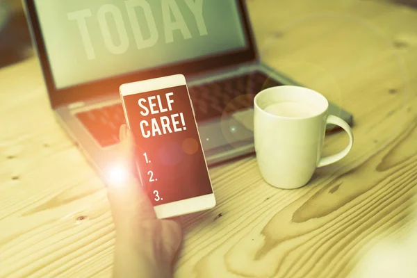 Word writing text Self Care. Business concept for practice of taking action preserve or improve ones own health woman laptop computer smartphone mug office supplies technological devices. — Stock Photo, Image