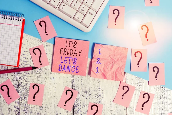 Handwriting text It S Friday Let S Dance. Concept meaning Celebrate starting the weekend Go party Disco Music Writing tools, computer stuff and math book sheet on top of wooden table.