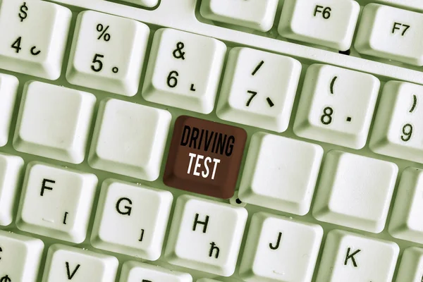 Handwriting text writing Driving Test. Concept meaning procedure to test a demonstrating s is ability to drive a motor vehicle White pc keyboard with empty note paper above white background key copy s
