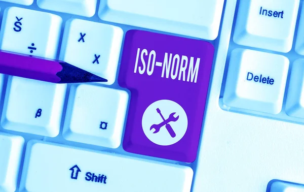 Text sign showing Iso Norm. Conceptual photo An accepted standard or a way of doing things most showing agreed White pc keyboard with empty note paper above white background key copy space. Royalty Free Stock Images