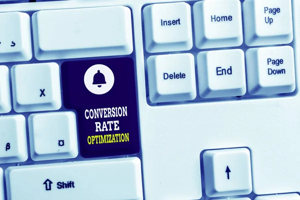 Writing note showing Conversion Rate Optimization. Business photo showcasing system for increasing percentage of visitors White pc keyboard with note paper above the white background.