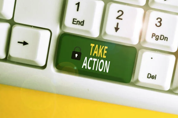 Text sign showing Take Action. Conceptual photo to do somethingoract in order to get a particular result White pc keyboard with empty note paper above white background key copy space.