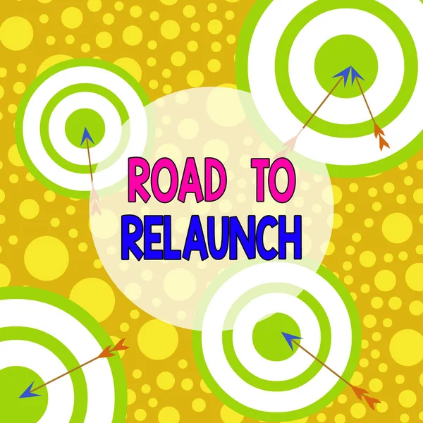 Text sign showing Road To Relaunch. Conceptual photo In the way to launch again Fresh new start Beginning Arrow and round target inside asymmetrical shaped object multicolour design. — Stockfoto