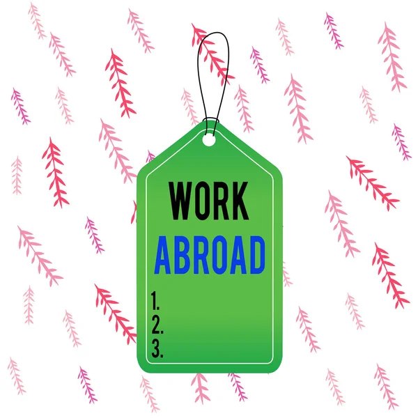 Handwriting text Work Abroad. Concept meaning Getting a job or working in a foreign geographical area Empty tag blank space colorful background label rectangle attached string.