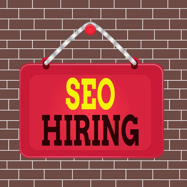 Text sign showing Seo Hiring. Conceptual photo employing a specialist will develop content to include keywords Board fixed nail frame string striped colored background rectangle panel.