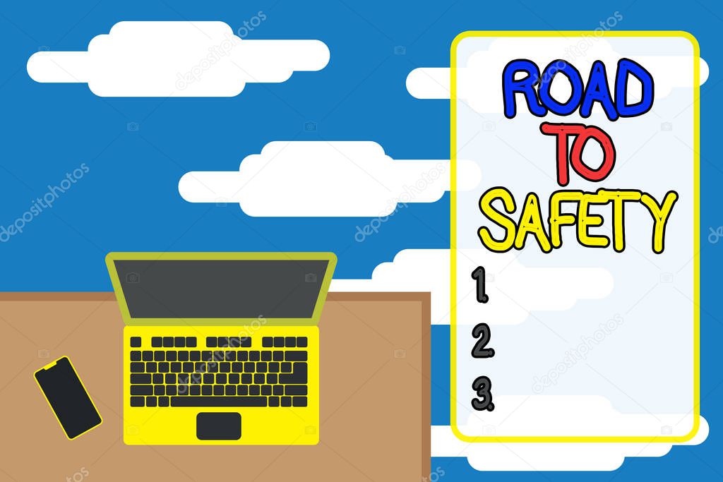 Word writing text Road To Safety. Business concept for Secure travel protect yourself and others Warning Caution Upper view office working place laptop lying wooden desk smartphone side.
