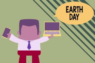Dünya Günü 'nü gösteren kavramsal el yazısı. Dünya çapında ekoloji çevresinin korunmasını kutlayan iş fotoğrafı sol cep telefonunda dizüstü bilgisayarı olan profesyonel bir adam..