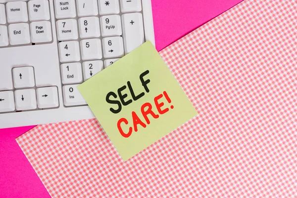 Text sign showing Self Care. Conceptual photo practice of taking action preserve or improve ones own health Note paper stick to computer keyboard near colored gift wrap sheet on table. — Stock Photo, Image