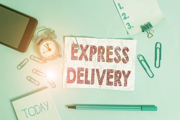 Text sign showing Express Delivery. Conceptual photo expediting the distributiuon of goods and services Alarm clock clips notepad smartphone rubber band marker colored background. — Stok fotoğraf