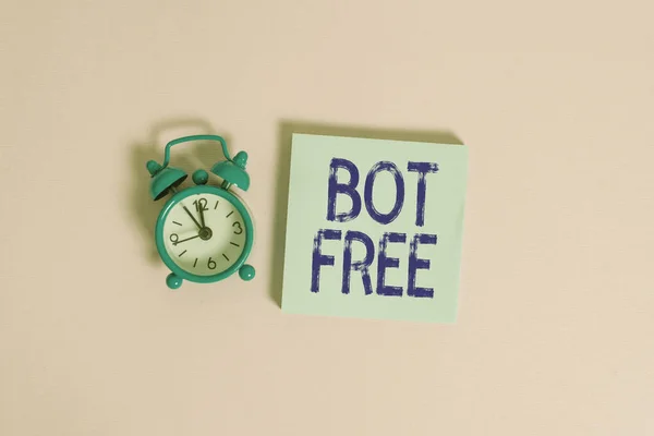 Writing note showing Bot Free. Business photo showcasing a computer program that works automatically Internet robots Vintage alarm clock wakeup blank notepad sticky note colored background.