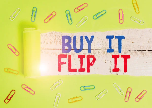 Text sign showing Buy It Flip It. Conceptual photo Buy something fix them up then sell them for more profit Paper clip and torn cardboard placed above a wooden classic table backdrop. — Stock Photo, Image