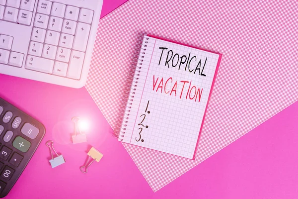 Handwriting text Tropical Vacation. Concept meaning taking a holiday in countries either side of the equator Writing equipments and computer stuffs placed above colored plain table. — 图库照片