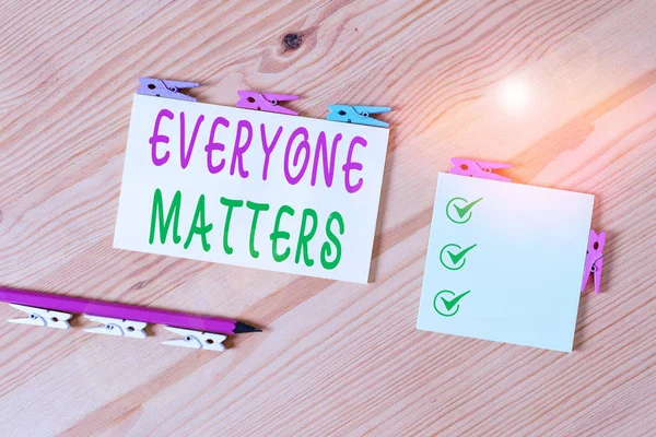 Word writing text Everyone Matters. Business concept for everything that happens is part of a bigger picture Colored clothespin papers empty reminder wooden floor background office.
