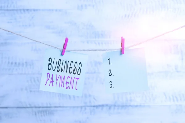 Text sign showing Business Payment. Conceptual photo trade of value from one party to another for goods Clothesline clothespin rectangle shaped paper reminder white wood desk.