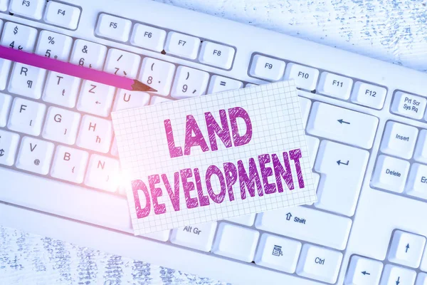 Word writing text Land Development. Business concept for process of acquiring land for constructing infrastructures White keyboard office supplies empty rectangle shaped paper reminder wood.