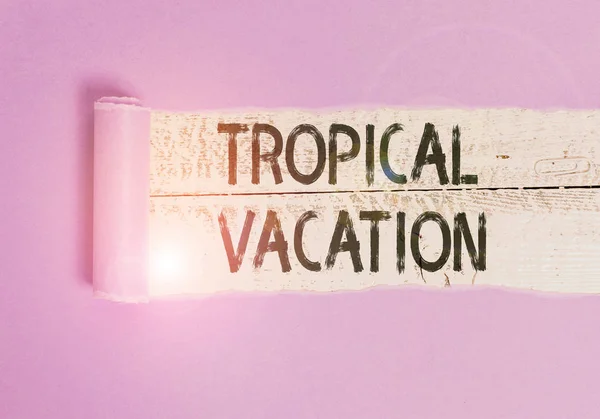 Writing note showing Tropical Vacation. Business photo showcasing taking a holiday in countries either side of the equator Cardboard which is torn placed above a wooden classic table. — Stock Photo, Image