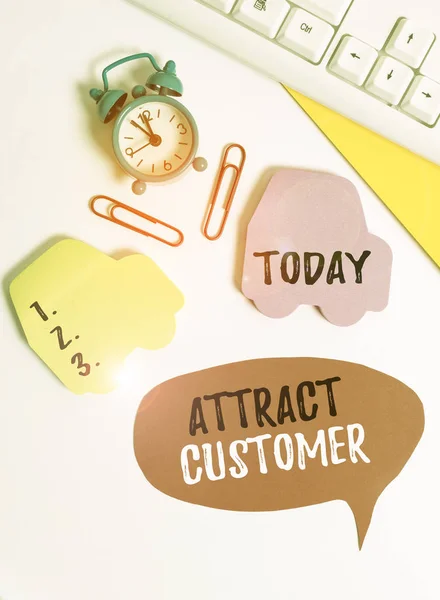 Writing note showing Attract Customer. Business photo showcasing to bring more customers or clients to your store or website Flat lay with copy space on bubble paper clock and paper clips.