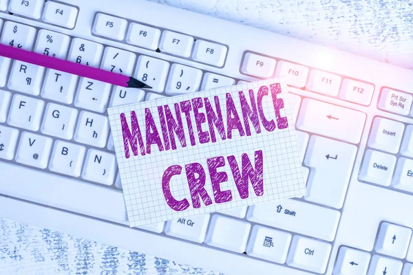 Word writing text Maintenance Crew. Business concept for responsible for maintenance and repair work of buildings White keyboard office supplies empty rectangle shaped paper reminder wood.