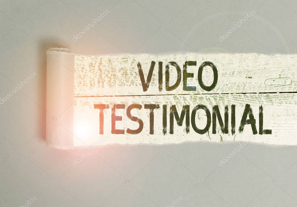 Writing note showing Video Testimonial. Business photo showcasing a statement testifying to benefits received in video Cardboard which is torn placed above a wooden classic table.
