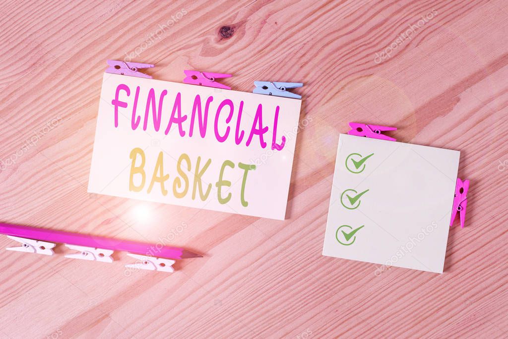 Word writing text Financial Basket. Business concept for group of securities created for simultaneous buy or sell Colored clothespin papers empty reminder wooden floor background office.