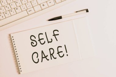 Conceptual hand writing showing Self Care. Business photo showcasing practice of taking action preserve or improve ones own health White pc keyboard with note paper above white background.