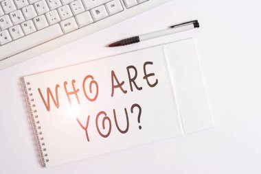 Conceptual hand writing showing Who Are You question. Business photo showcasing asking about demonstrating identity or information White pc keyboard with note paper above white background.