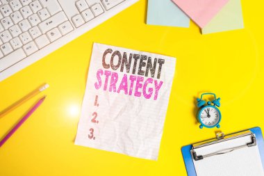 Text sign showing Content Strategy. Conceptual photo the planning development and analysisagement of content Copy space on notebook above yellow background with keyboard on table.