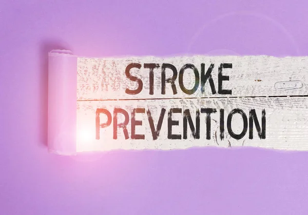 Writing note showing Stroke Prevention. Business photo showcasing identified demonstratingal risk factors and change lifestyle Cardboard which is torn placed above a wooden classic table.