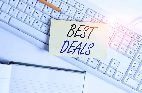 Word writing text Best Deals. Business concept for very successful transaction or business agreement or a bargain White pc keyboard with empty note paper and paper clips above white background.