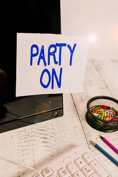 Conceptual hand writing showing Party On. Business photo text Keep or continue having a great time even after something happens Note paper taped to black screen near keyboard stationary. — Stock Photo, Image