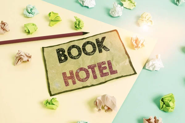 Handschrift Textschreiben Buch Hotel. Konzept bedeutet eine Anordnung, die Sie treffen, um ein Hotelzimmer oder eine Unterkunft haben farbige zerknüllte Papiere leer Erinnerung blau gelb Hintergrund Wäscheklammer. — Stockfoto
