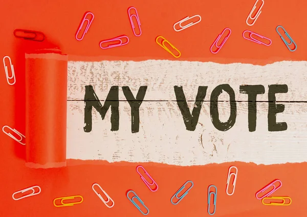 Text sign showing My Vote. Conceptual photo the act of showing your choice or opinion in an election or meeting Paper clip and torn cardboard placed above a wooden classic table backdrop. — Stock Photo, Image