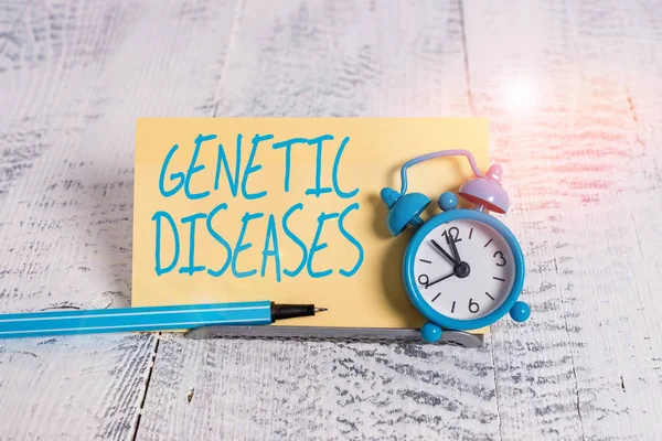 Handwriting text Genetic Diseases. Concept meaning disease caused by an abnormality in an individual s is genome Mini blue alarm clock stand tilted above buffer wire in front of notepaper.