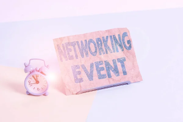 Text sign showing Networking Event. Conceptual photo Developing and using contacts made in business for purposes Mini size alarm clock beside a Paper sheet placed tilted on pastel backdrop.