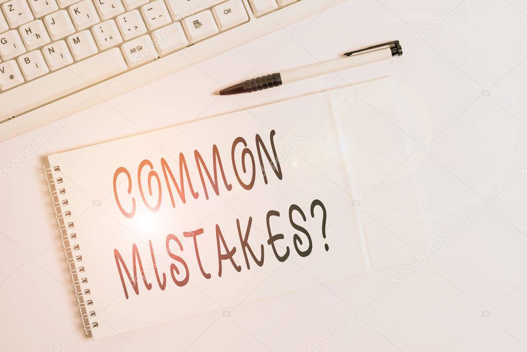 Conceptual hand writing showing Common Mistakes question. Business photo showcasing repeat act or judgement misguided or wrong White pc keyboard with note paper above white background.