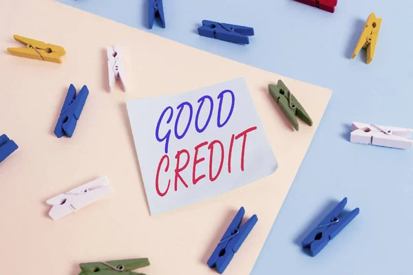 Text sign showing Good Credit. Conceptual photo borrower has a relatively high credit score and safe credit risk Colored clothespin paper empty reminder yellow blue floor background office.