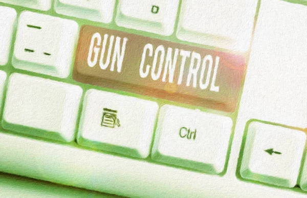 銃規制を示すメモを書く。銃の所持を制限することを目的とした法的措置を示すビジネス写真白い背景の上にノートPCのキーボード. — ストック写真