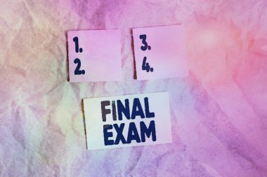 Word writing text Final Exam. Business concept for test given to student at the end of a course of study or training Papercraft craft paper desk square spiral notebook office study supplies.