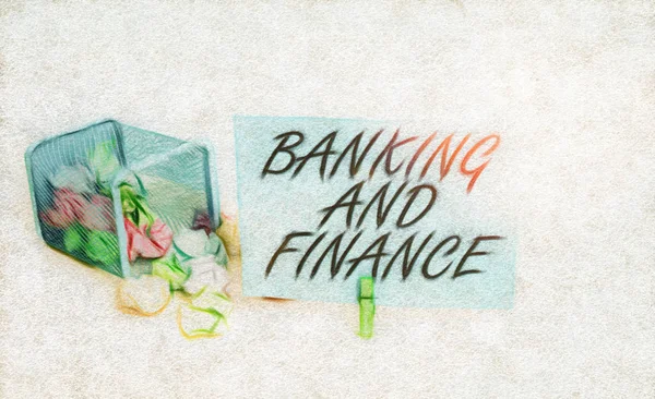 Writing note showing Banking And Finance. Business photo showcasing Accounting and entities stocks Money interests Trash bin crumpled paper clothespin reminder office supplies.