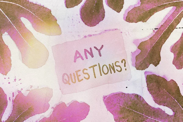 Text sign showing Any Questions Question. Conceptual photo you say write order to ask demonstrating about something Leaves surrounding notepaper above a classic wooden table as the background.