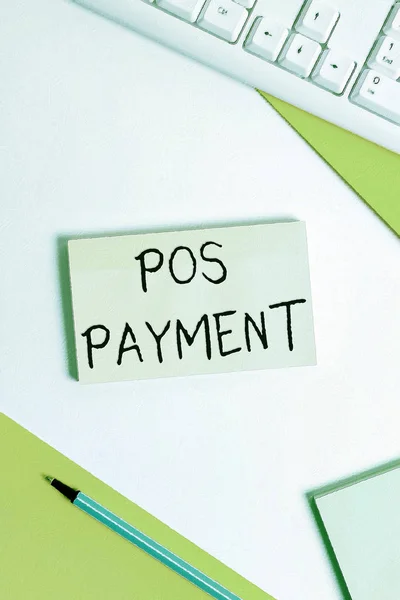 Text sign showing Pos Payment. Conceptual photo customer tenders payment in exchange for goods and services Flat lay above table with pc keyboard and copy space paper for text messages.